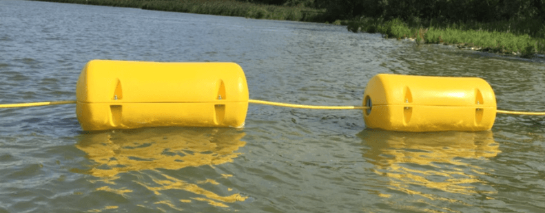 Two yellow savings connected to a rope in stagnant water.