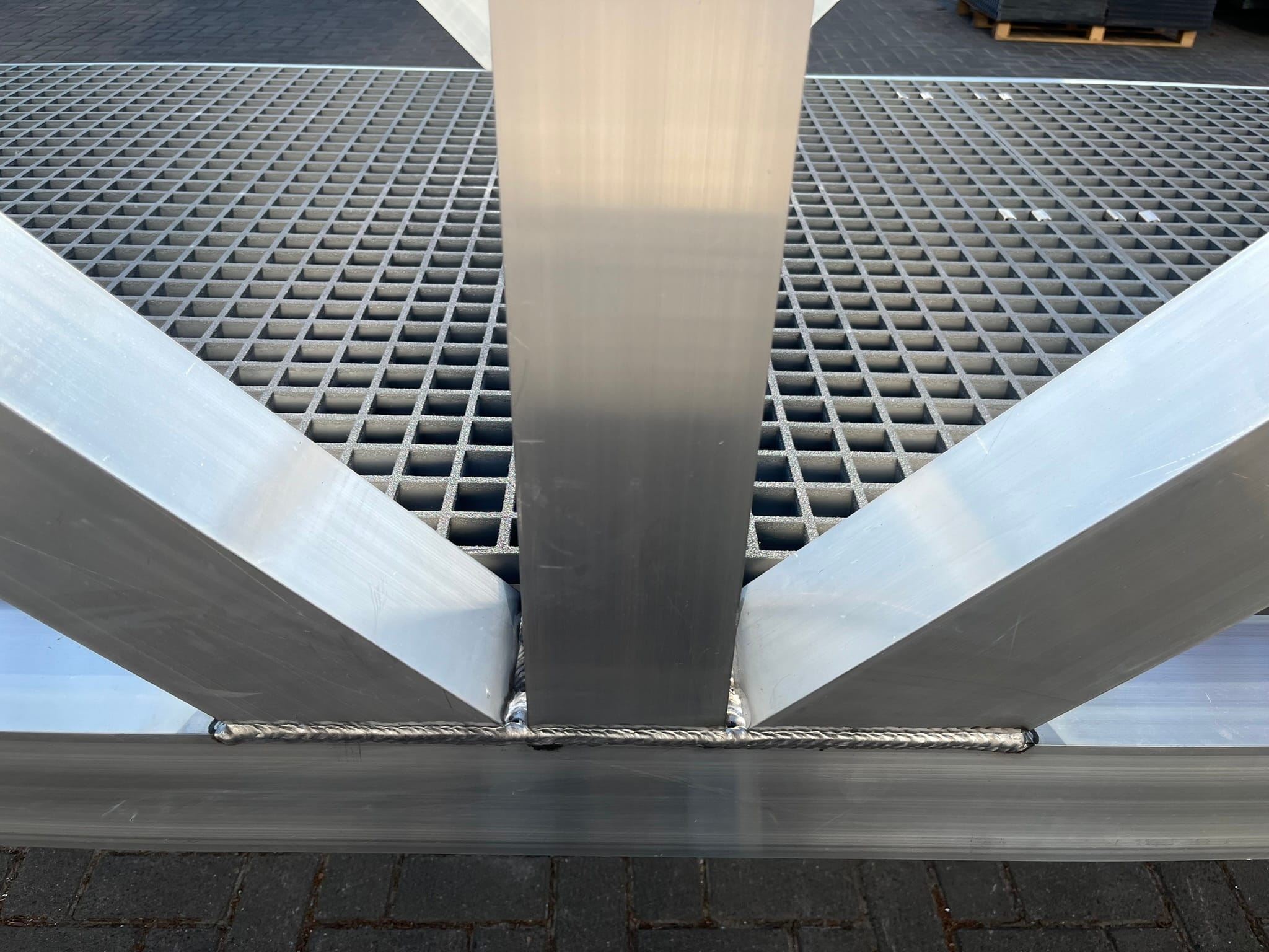 Detail des geschweißten Aluminiumverbindungsverbinds und des Anti-Rutsch-Geverka-Gitters in einem Gehwegbau.